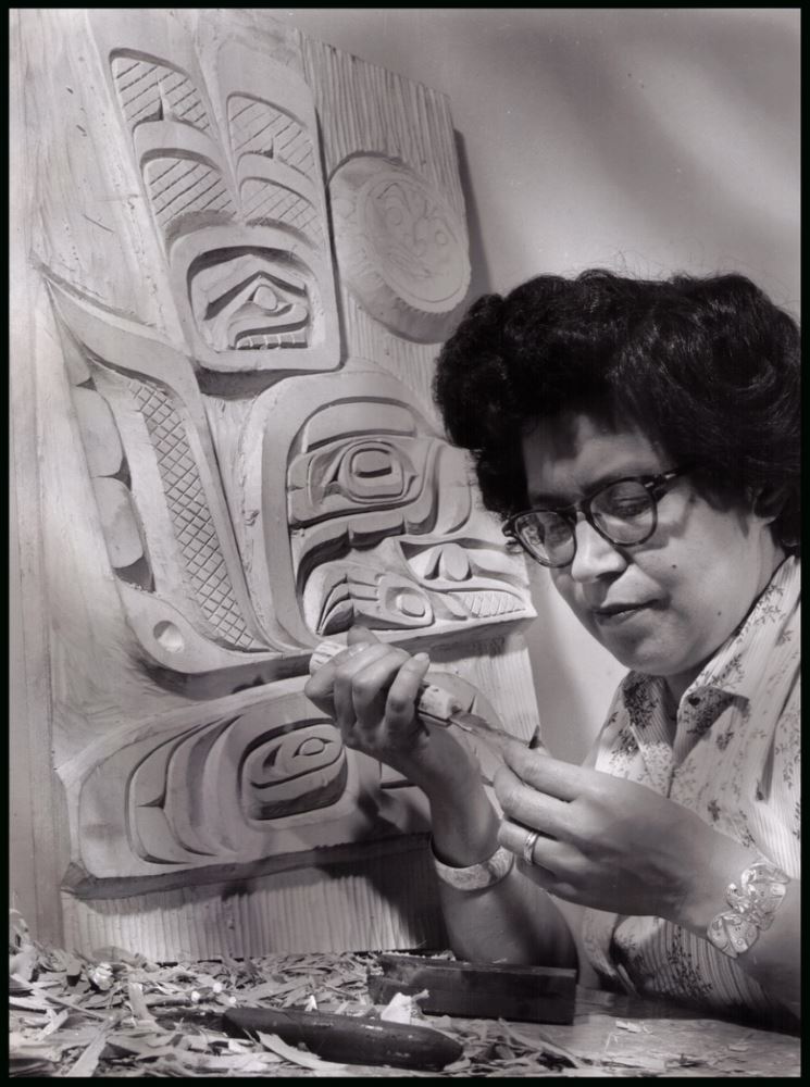 Ellen Neel carving a model totem in Vancouver, BC.